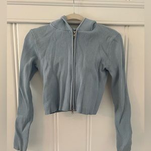 Light blue zip up hoodie.